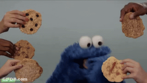 Sesame Street Cookie Monster Being Surrounded By People Holding Cookies GIF