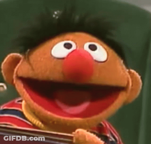 Sesame Street Puppet Holding Book Smiling GIF