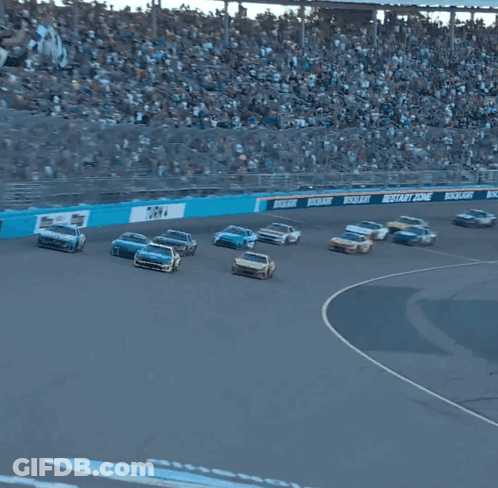 Several Cars Are Racing On A Race Track With A Sign That Says Championship GIF