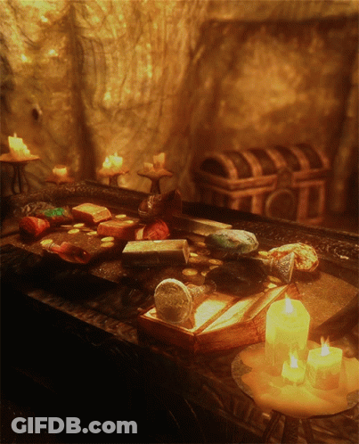 Several Lit Candles On Table With Book GIF