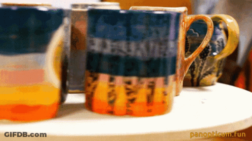 Several Mugs Lined Up With Panopticum.fun GIF
