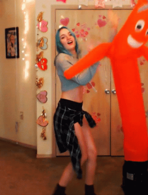 Sexy Lady Dancing With Inflatable Tube Man GIF