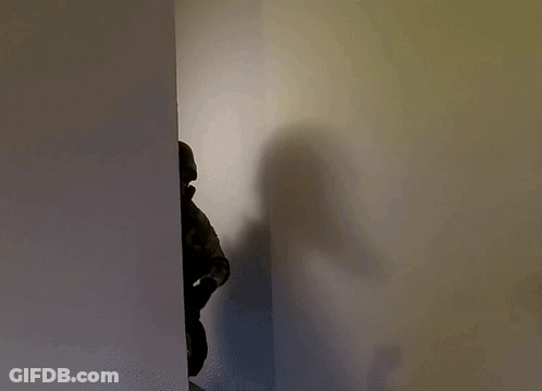 Shadow Of Person In Helmet And Gas Mask GIF