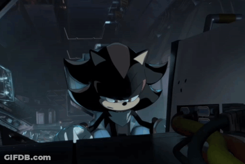 Shadow The Hedgehog Is Sitting In A Dark Room Looking At Something GIF