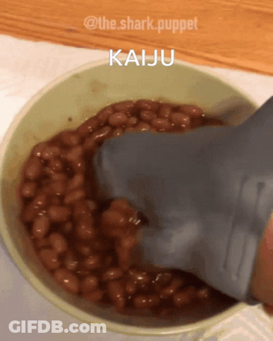 Shark Puppet Pouring Beans Into Bowl GIF