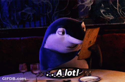 Shark Sitting At Table With A Lot Sign GIF