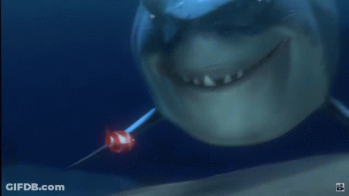 Shark With Clown Fish In Mouth GIF