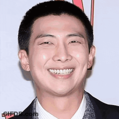 Shaved Head Man Smiling In Suit And Tie GIF