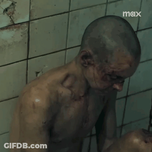 Shaved Head Man Standing Before Tiled Wall Saying Max GIF