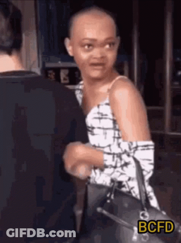 Shaved Head Woman Holding Purse Talking GIF