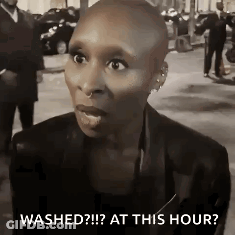 Shaved Head Woman Talking On Street GIF