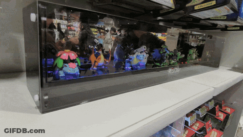 Shelf Full Of Stuffed Pokemon Squirtle And Flareon GIF