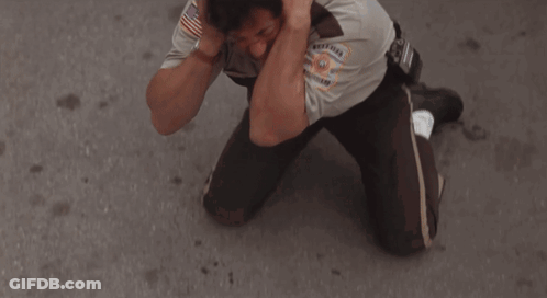 Sheriff Covering Ears In Front Of White Van GIF
