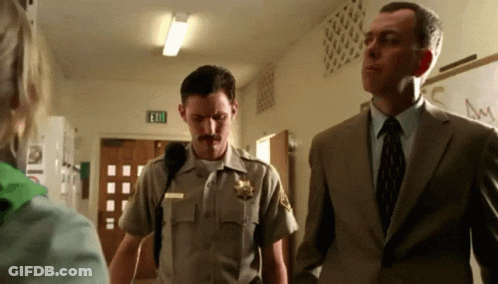 Sheriff In Uniform Next To Suit Man GIF