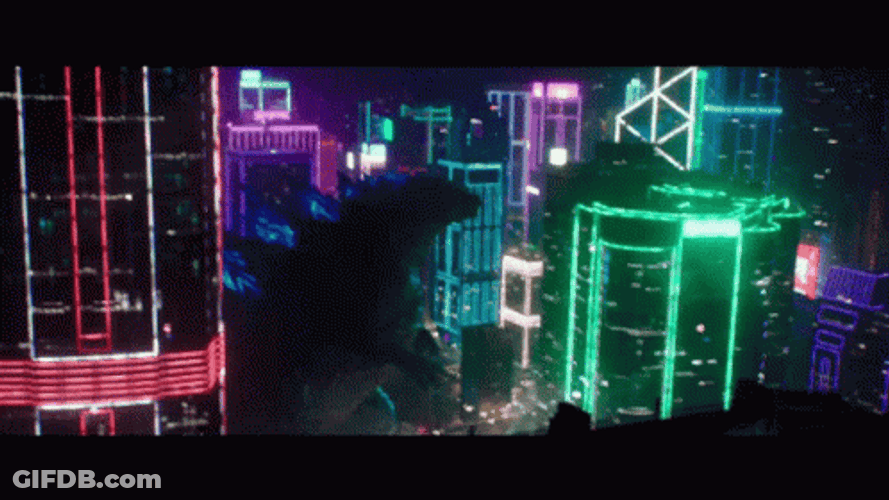 Shin Godzilla Passing Thru Lighted Buildings GIF