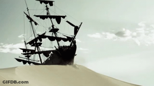 Ship Silhouetted Against Cloudy Sky On Sand Dune GIF