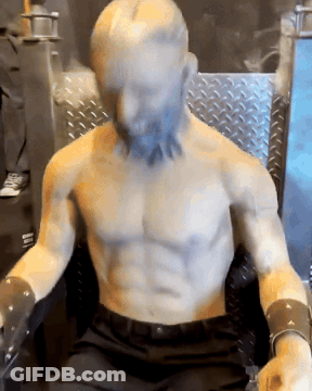 Shirtless Beard Statue Sitting In Chair GIF
