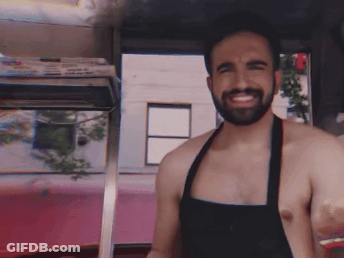 Shirtless Bearded Man In Apron Smiling GIF