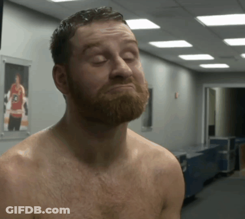 Shirtless Bearded Man In Hallway With Hockey Picture GIF