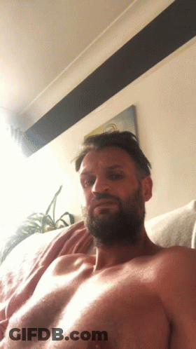 Shirtless Bearded Man Laying On Couch GIF