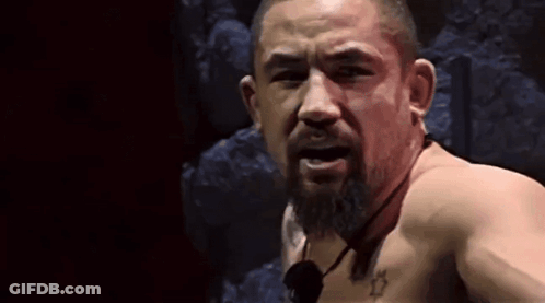 Shirtless Bearded Man Looking At Camera With Microphone GIF