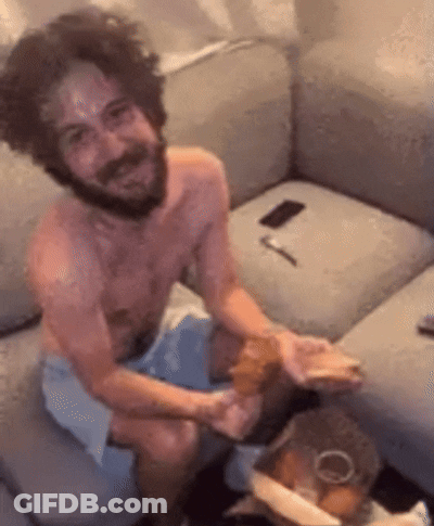 Shirtless Bearded Man Sitting On Couch GIF