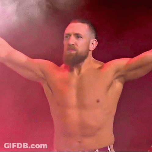 Shirtless Bearded Man Stands In Front Of Red Background GIF