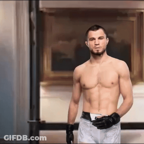 Shirtless Boxer Standing In Front Of Framed Picture GIF