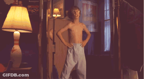 Shirtless Boy Dancing In Dark Room With Lamp GIF