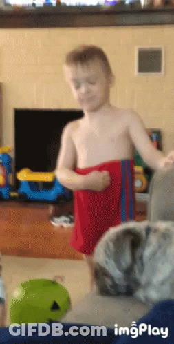 Shirtless Boy In Red Shorts Standing With Cat GIF