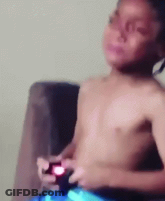 Shirtless Boy Playing Video Game On Couch GIF
