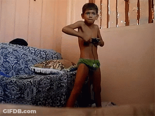 Shirtless Boy Playing Video Game With Controller GIF