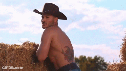 Shirtless Cowboy Leaning On Hay Bale GIF