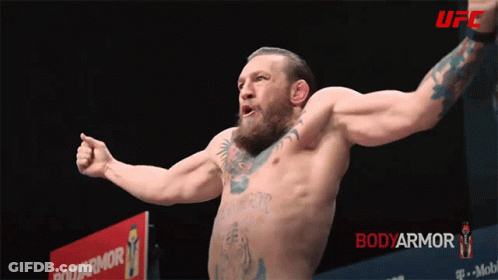 Shirtless Fighter In Front Of Bodyarmor Sign GIF