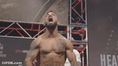 Shirtless Fighter In Front Of Hea Sign GIF