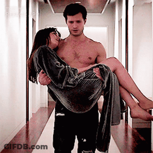 Shirtless Man Carrying Woman In Hallway GIF