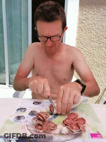 Shirtless Man Cutting Meat GIF