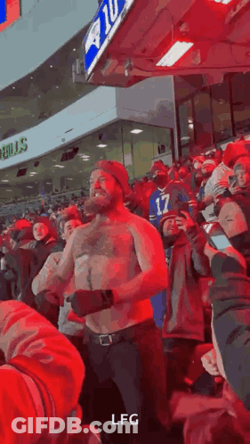 Shirtless Man Dancing At Sports Game GIF