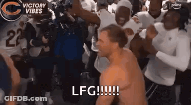 Shirtless Man Dancing In Front Of Football Players GIF