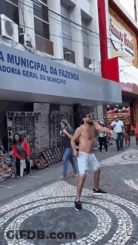 Shirtless Man Dancing In Front Of Municipal Da Fazenda Building GIF