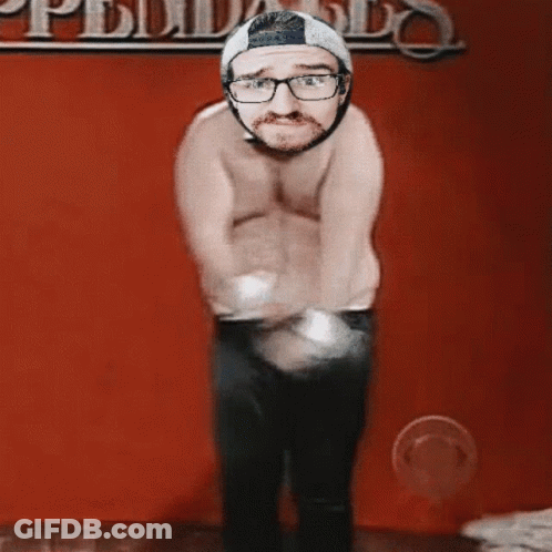 Shirtless Man Dancing In Front Of Pueblo Wall GIF