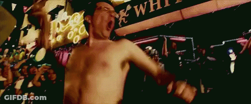 Shirtless Man Dancing In Front Of White Sign GIF