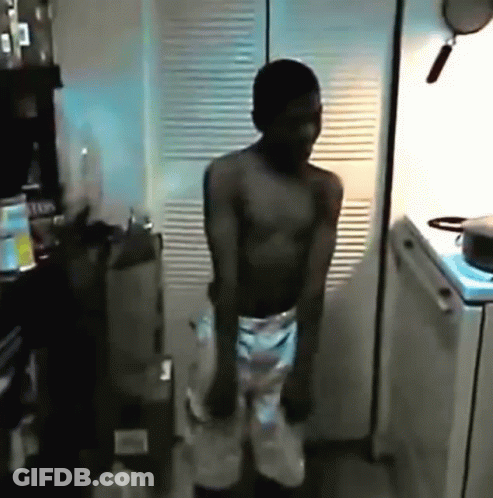 Shirtless Man Dancing In Kitchen With Pot On Stove GIF