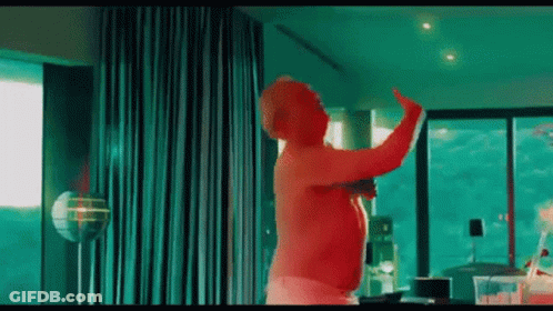 Shirtless Man Dancing With Green Curtain GIF
