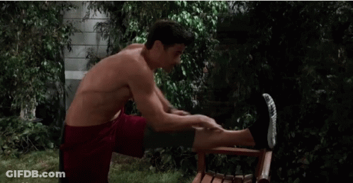 Shirtless Man Doing Leg Exercises On Chair Outside GIF