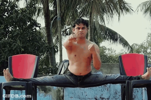 Shirtless Man Doing Split On Chair GIF