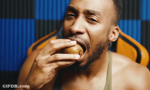 Shirtless Man Eating Kiwi GIF