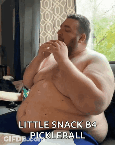 Shirtless Man Eating Pickleball On Couch GIF