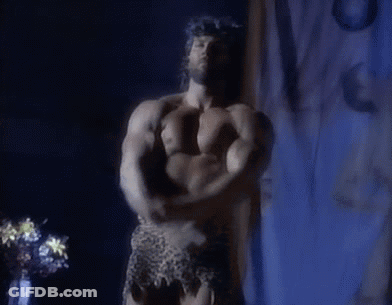 Shirtless Man Flexing Muscles In Dark Room GIF