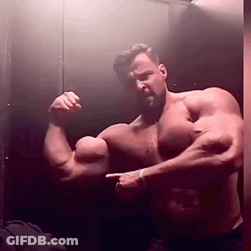 Shirtless Man Flexing Muscles In Mirror GIF